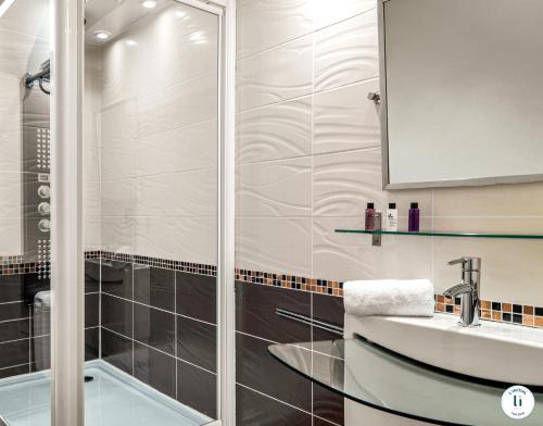a bathroom with a shower and a sink at L'Initial in Toulouse