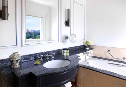 a bathroom with a sink and a window at InterContinental Singapore by IHG in Singapore