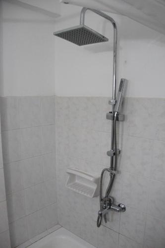 a shower with a shower head in a bathroom at Voula's Casa Di Mare in Palekastron