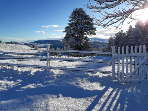 a white fence in the snow on a hill at Kod Gruja in Ribnica