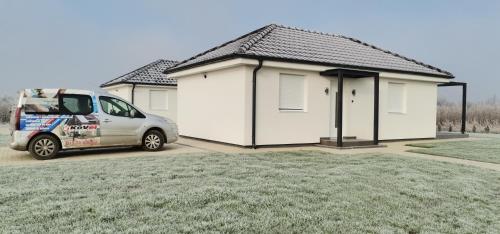 a van parked in front of a house at KoVeL apartmani - Termalna Rivijera in Bogatić