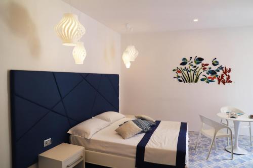 a small bedroom with a bed and a table at Palazzo San Giovanni Amalfi Coast in Scala