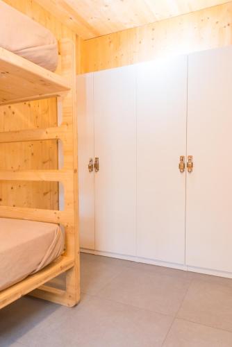 a bedroom with two bunk beds and white cabinets at Wanderlust José Ignacio in José Ignacio