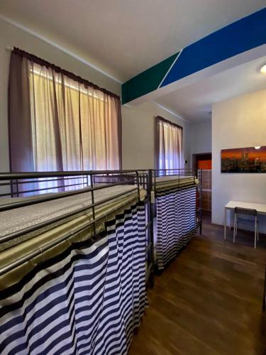 a room with two beds and a table at Ametyst Hostel in Krakow