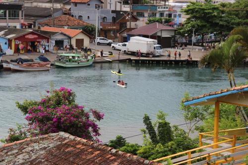a group of people in a boat in a river at Nosso Lounge Hostel in Florianópolis