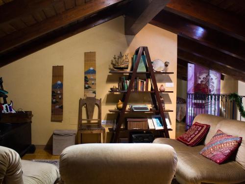a living room with a couch and a book shelf at CASA CASTAÑÉ in Puente de Domingo Flórez