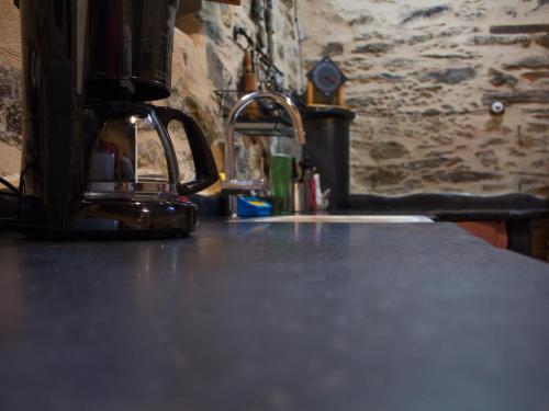 a coffee pot sitting on top of a counter at CASA CASTAÑÉ in Puente de Domingo Flórez