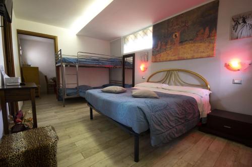 a bedroom with a bed and a desk at For Ever Apartments in Fiumicino