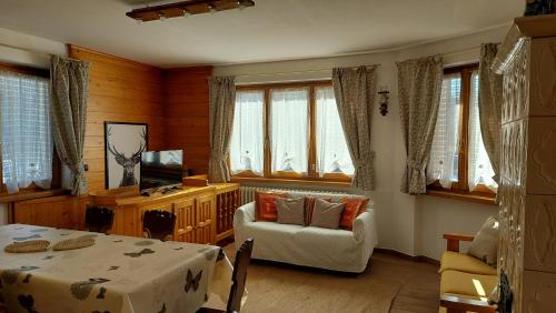 sala de estar con mesa y silla en Appartamento Elena, en Bormio