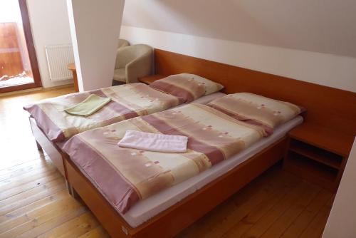 a bed with two pillows on it in a room at Tri studničky Správa TANAPu in Vysoké Tatry