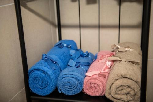 a bunch of towels and towels on a shelf at Raphael Apartment North Bucharest Cosmopolis in Ştefăneştii de Jos