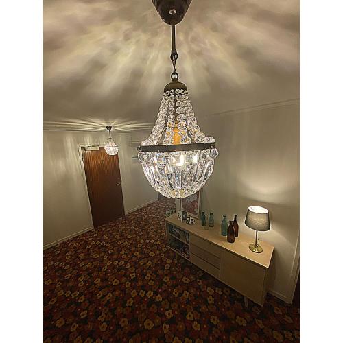 a chandelier hanging from a ceiling in a room at Hotell Värend in Växjö