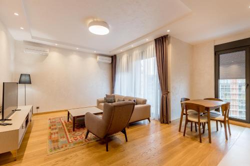 a living room with a couch and a table at Athos Square Apartments in Podgorica
