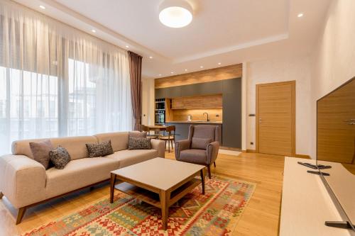 a living room with a couch and a table at Athos Square Apartments in Podgorica