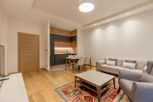 a living room with a couch and a table at Athos Square Apartments in Podgorica
