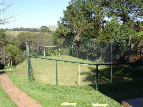 a soccer field with a fence and a goal at Spazio Farfalla in Itupeva