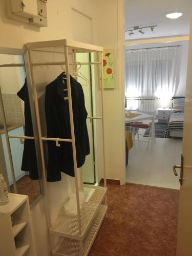 a closet with a black jacket on a rack at Studio apatrman Pijalović in Bjelovar