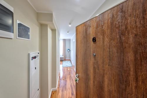 a large wooden door in a room with a hallway at Onix Residence in Zlatibor