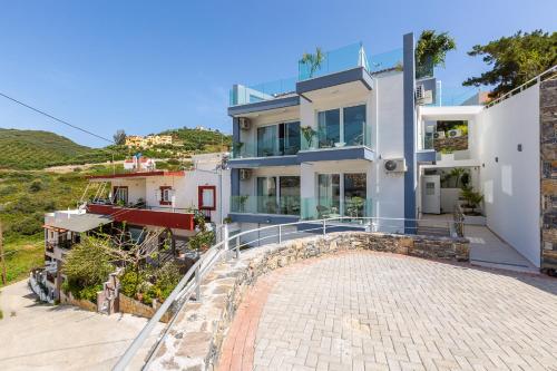 a house on a hill with a driveway at Akrogiali Apartments "by Checkin" in Balíon
