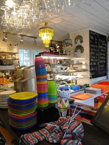 a kitchen with a counter with colorful plates and a counter at Hotel & Cafe Lanterna in Nauvo