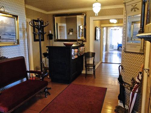 a living room with a couch and a chair at Hotel & Cafe Lanterna in Nauvo