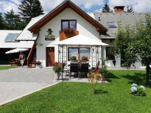 a house with a table and chairs in a yard at PR`Cajhn in Radovljica