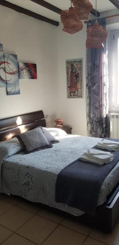 a bedroom with a bed with a blue comforter at B&B Pierilu' in Grosseto