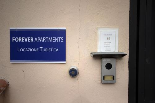 a sign that is on the wall of a building at For Ever Apartments in Fiumicino