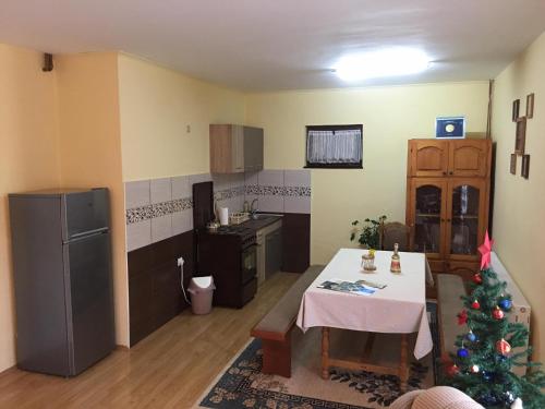 a kitchen with a table and a christmas tree in it at Zvezdica in Bajina Bašta
