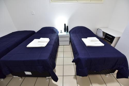 a room with two blue beds in a room at LIVE IN FORTALEZA HOTEL in Fortaleza