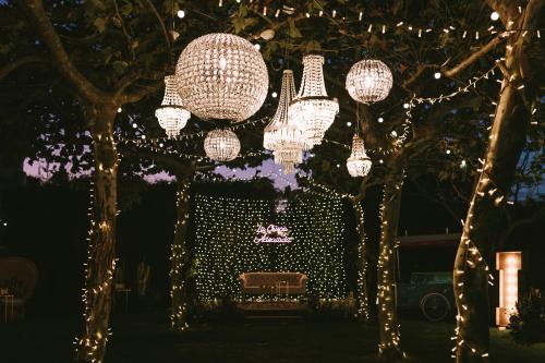 a park with lights and a bench under trees at Blanco Hotel Spa in Navia