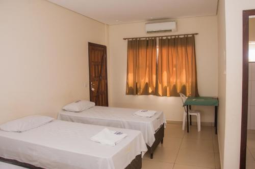 Tempat tidur dalam kamar di Hotel Novo Lar