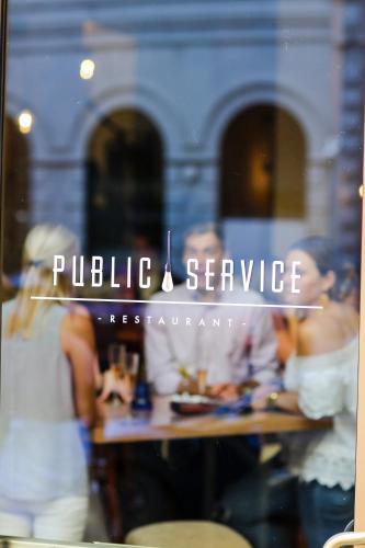 a reflection of people in a restaurant window at NOPSI Hotel New Orleans in New Orleans
