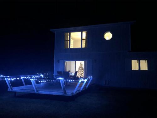 a house with christmas lights in front of it at night at Entire waterfront cottage in carrying place in Carrying Place