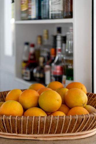 a basket of oranges sitting on a table at Lithos by Spyros & Flora in Agios Ioannis Mykonos