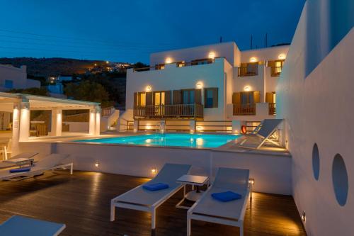 a villa with a swimming pool at night at Lithos by Spyros & Flora in Agios Ioannis Mykonos