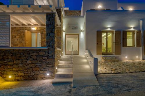 a stairway leading to a building at night at Lithos by Spyros & Flora in Agios Ioannis Mykonos