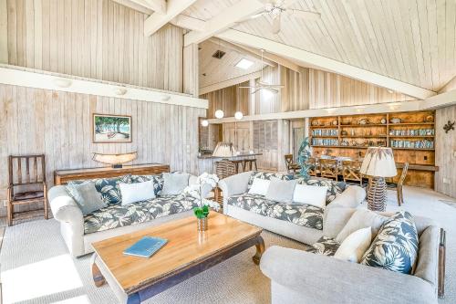 a living room with two couches and a table at Sandcastles TVNC#1305 in Anahola