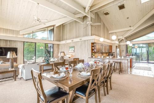 a dining room with a wooden table and chairs at Sandcastles TVNC#1305 in Anahola