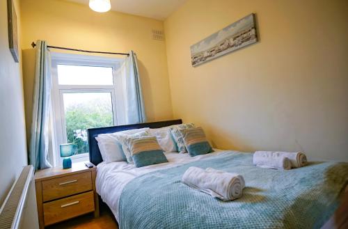 a bedroom with a bed with towels on it at West Lea House in Chesterfield