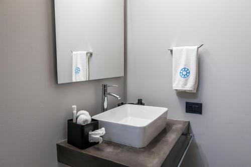 a bathroom with a white sink and a mirror at Casa Olié in Oaxaca City