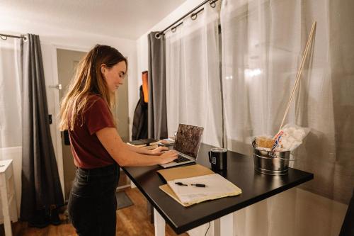 a woman standing at a table with a laptop at LOGE Bend in Bend