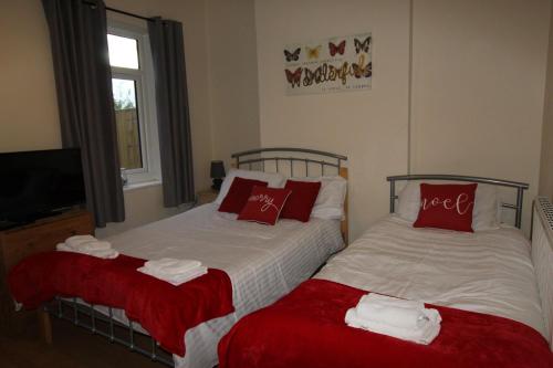 A bed or beds in a room at West Lea House