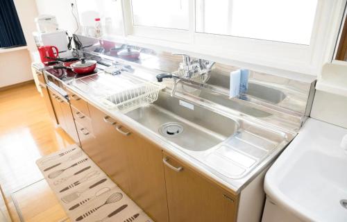 a kitchen with a sink and a box in it at STAY IN TOKIWA - Vacation STAY 16336v in Asahikawa