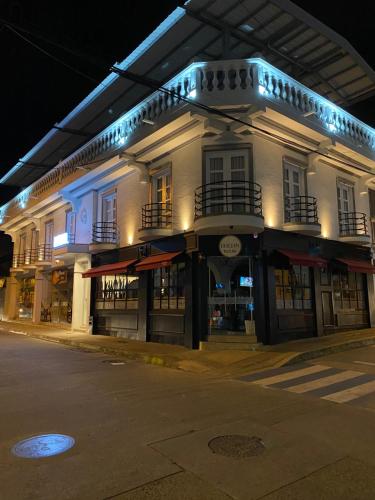 a lit up building on a street at night at Hotel Válcon in Santa Rosa de Cabal