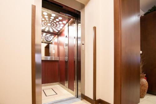 a glass elevator door in a building at Hotel Giovanni Giacomo in Teplice