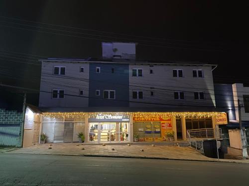 a building with christmas lights in front of a store at Hotel Somensi in Bento Gonçalves
