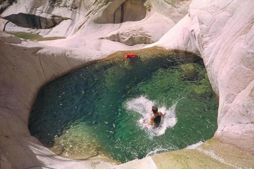 a person in a pool of water in a cave at Un je ne sais quoi de Paradis in Les Vans