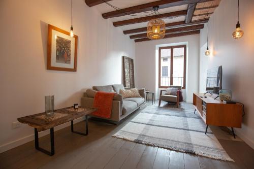 een woonkamer met een bank en een tafel bij LaSuitedu12 - Aprtement for 2 people view of the Old Prison in Annecy