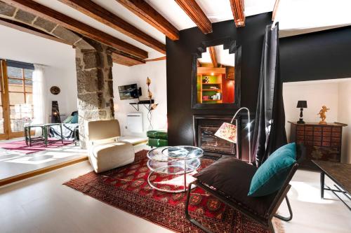 a living room with a table and a fireplace at Le Balcon du Palais de l'Isle - Aprtement 4 with stunning views in Annecy